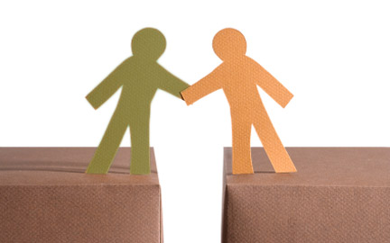 Two cut-out people shaking hands